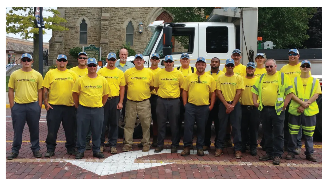 CurbCo crew in company shirts in front of a CurbCo service vehicle