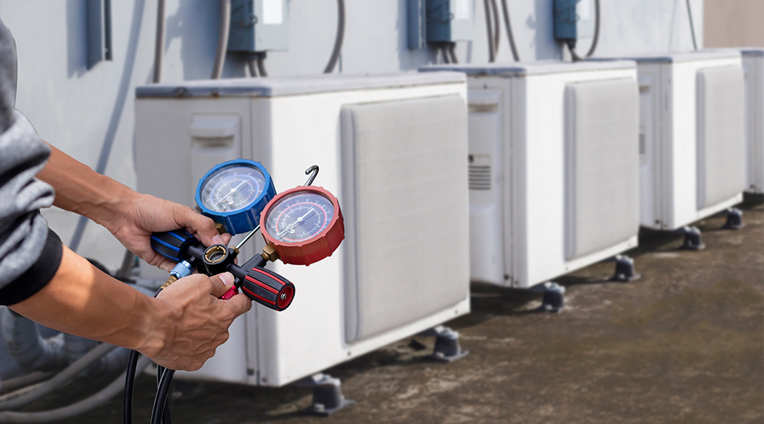 HVAC technician reviewing equipment data